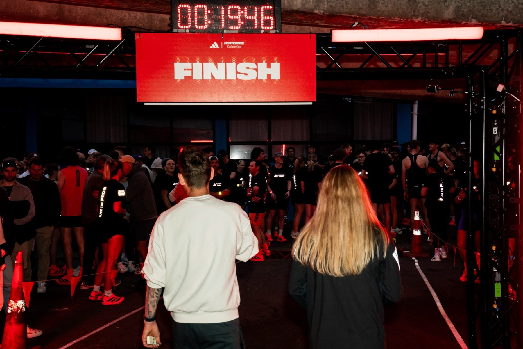 Walking to the red finish sign with the race clock above