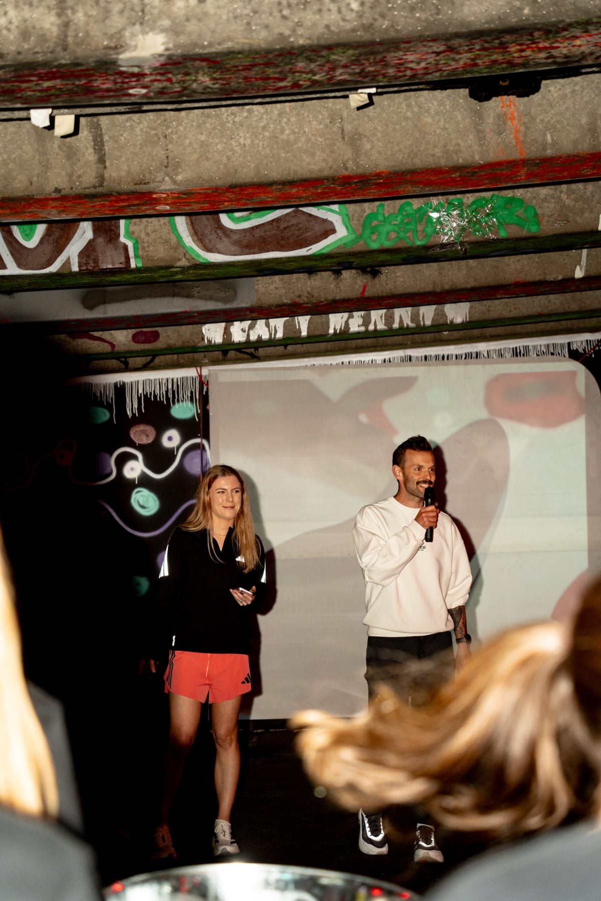 Maya and Oska on stage under the Sydenham underpass